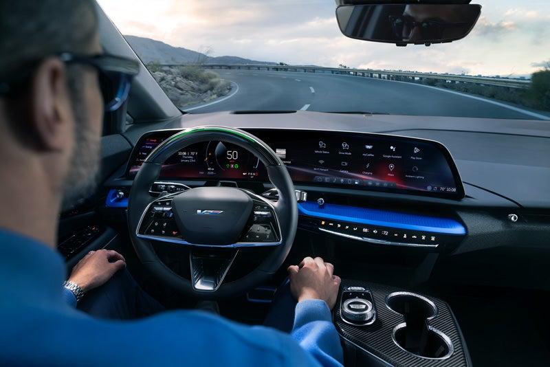 Front View of the 2026 OPTIQ-V Driving Through the Dusk Utilizing its Headlights | Coughlin Cadillac Circleville in Circleville OH